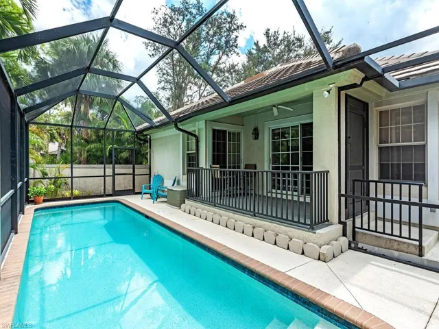 Screened in saltwater lap pool with deck area
