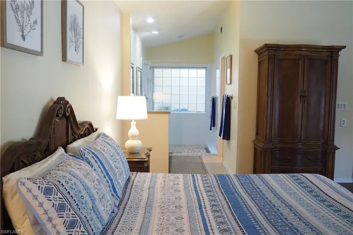 Bedroom with lofted ceiling
