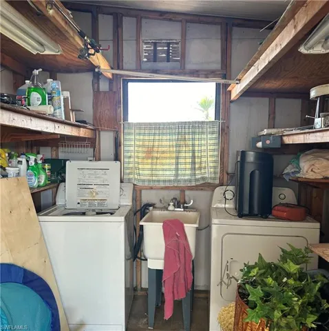 Washroom featuring sink and washer and clothes dryer