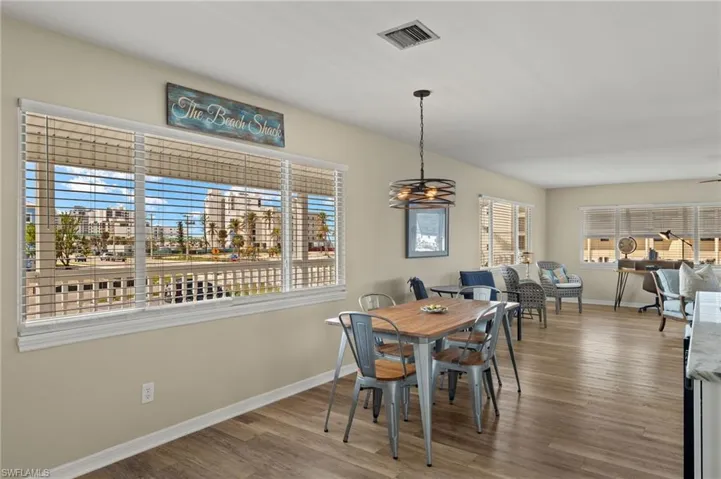 Dining area with baseboards, visible vents, and wood finished floors