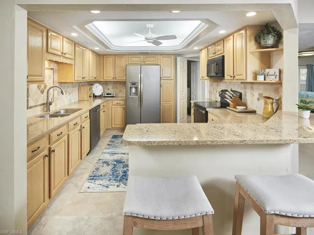 The location of the kitchen allows for conversation with guests while preparing meals.