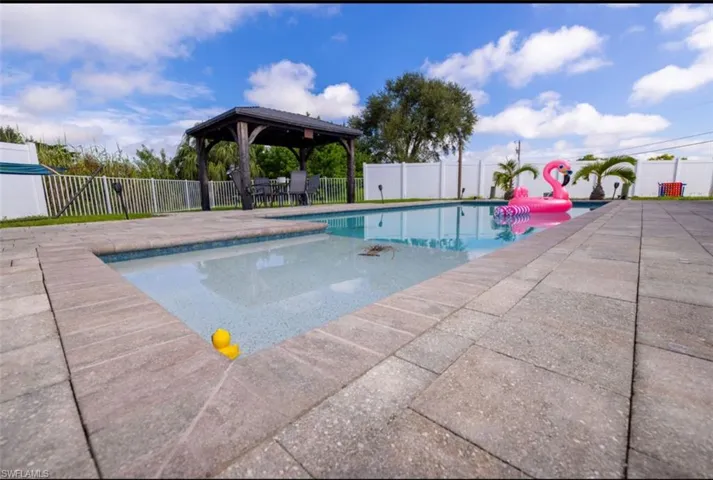View of swimming pool with a gazebo and a patio