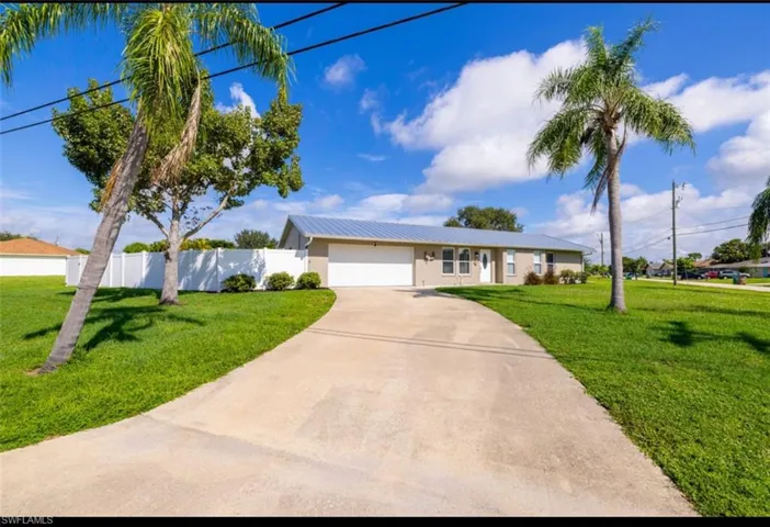 Single story home featuring a front lawn and a garage
