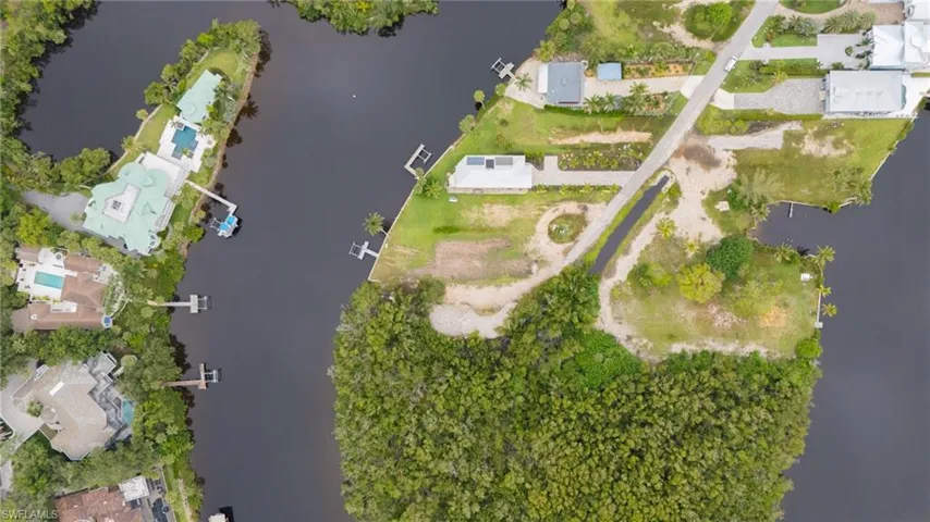 Aerial view of property's location with a large body of water and nearby suburban area