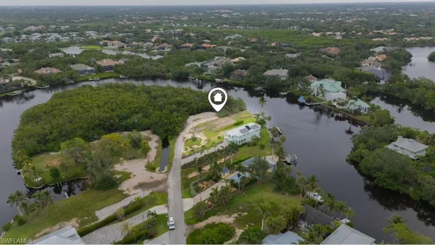Aerial overview of property's location with a nearby body of water and nearby suburban area