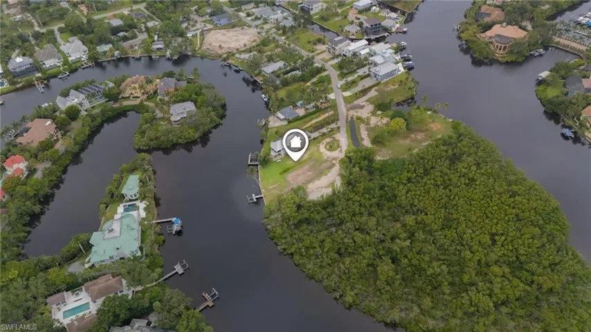 View of property location featuring a large body of water and nearby suburban area