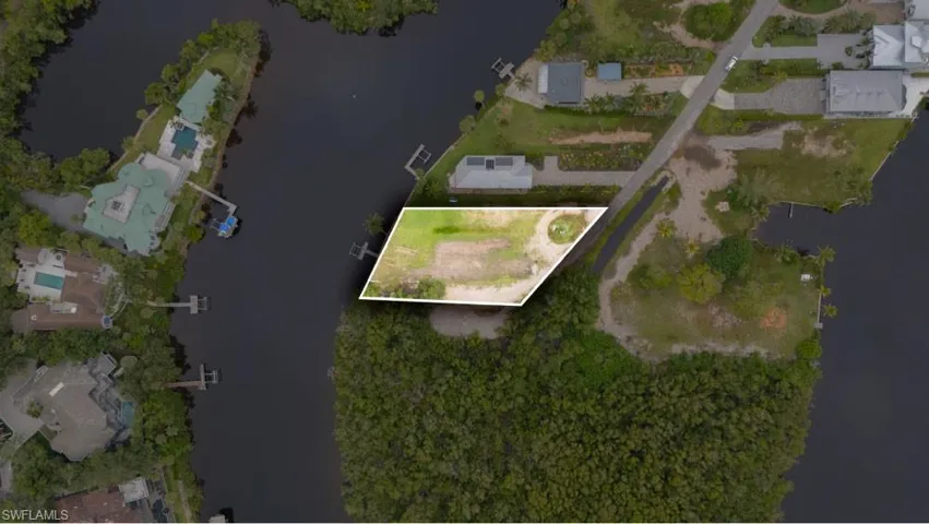 Aerial overview of property's location featuring property parcel outlined and nearby suburban area