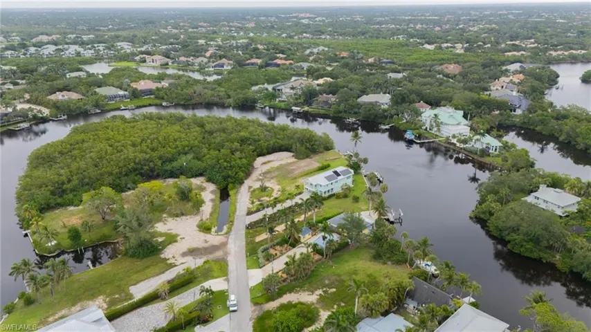 View of property location with a large body of water and nearby suburban area