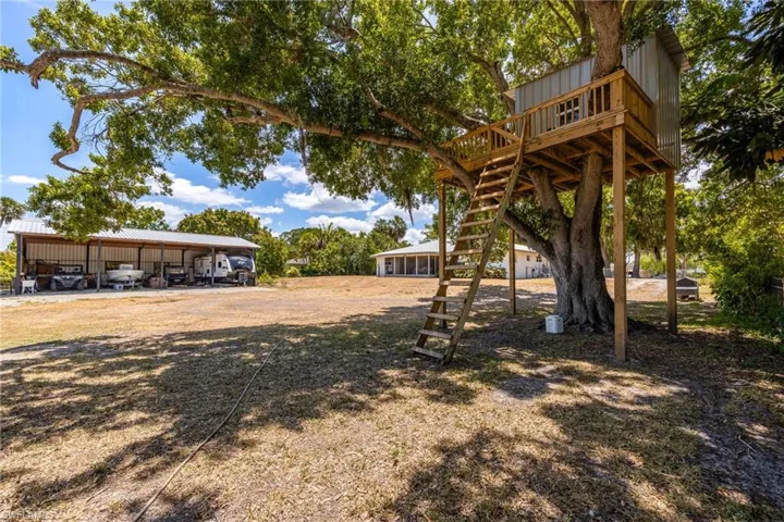 View of yard with stairway and a deck