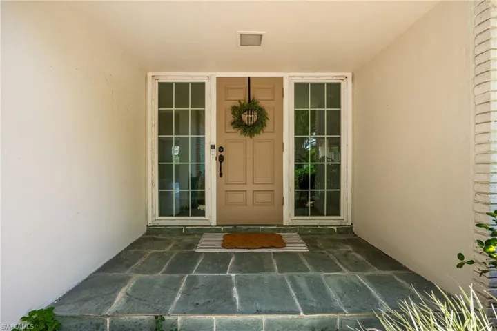 View of exterior entry with stucco siding
