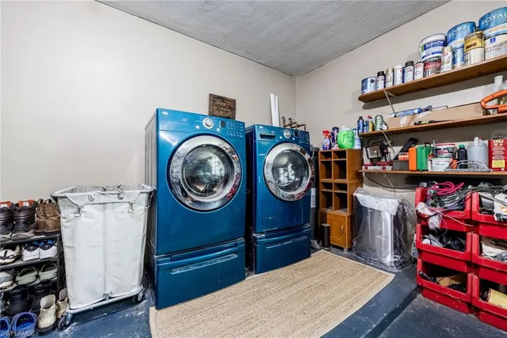 Laundry room featuring washing machine and clothes dryer and laundry area