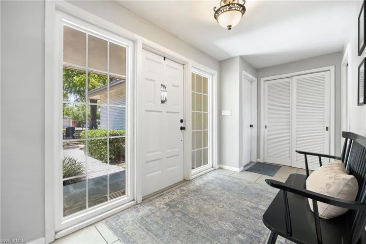 Tiled entrance foyer with baseboards