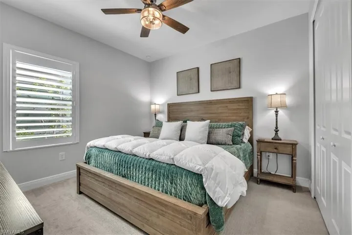 Bedroom featuring a closet, carpet floors, and a ceiling fan