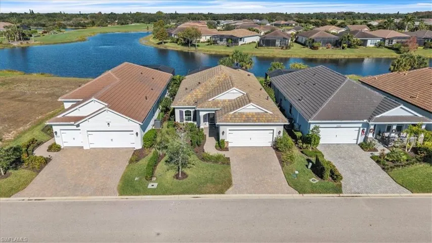 Aerial perspective of suburban area featuring a large body of water