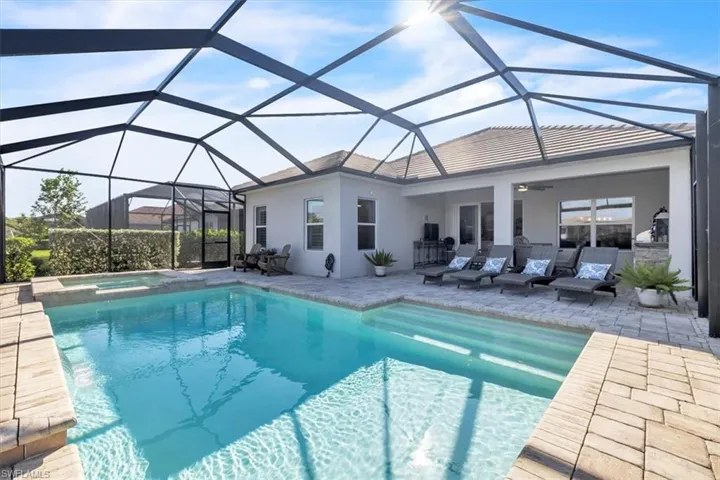 View of swimming pool with a sunroom, a lanai, and a patio