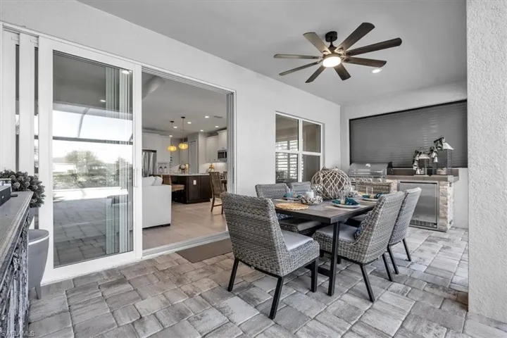 View of patio / terrace with area for grilling, ceiling fan, and outdoor dining area