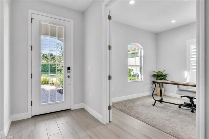 Foyer entrance with wood tiled floors and recessed lighting