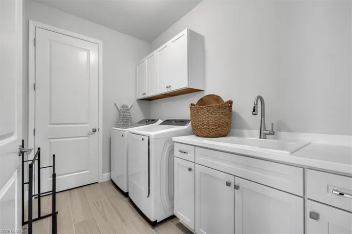Laundry room featuring cabinet space and washer and clothes dryer