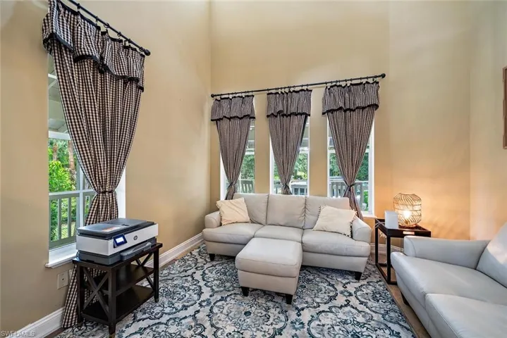 Living room with healthy amount of natural light and a towering ceiling