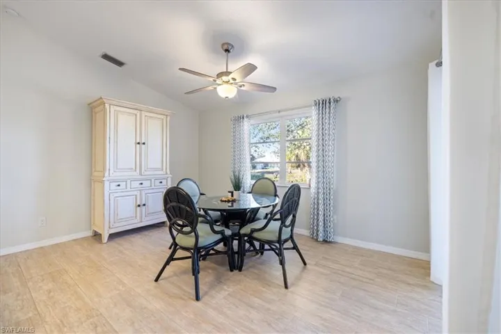 Dining room with ceiling fan and lofted ceiling