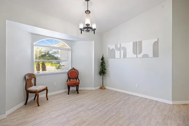 Sitting room with an inviting chandelier and light wood-type flooring