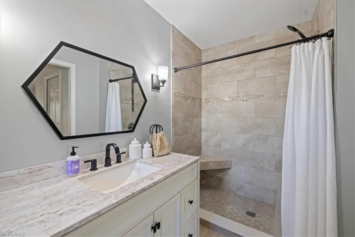 Bathroom featuring vanity and a shower with shower curtain