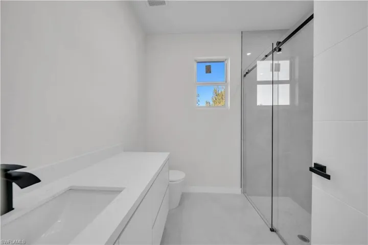 Bathroom with a shower stall and vanity