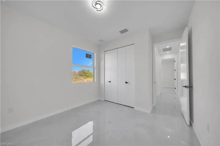 Unfurnished bedroom featuring baseboards and a closet