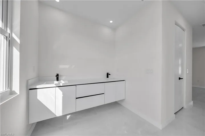 Bathroom featuring double vanity and recessed lighting
