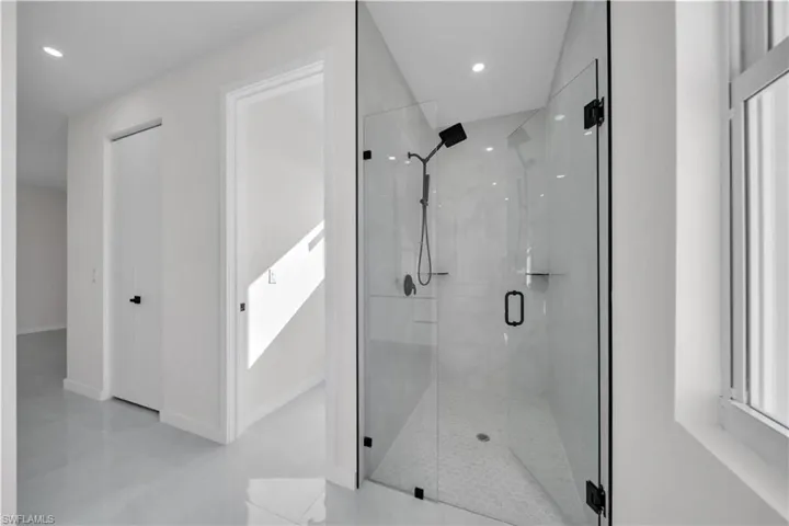 Full bathroom with a shower stall and recessed lighting