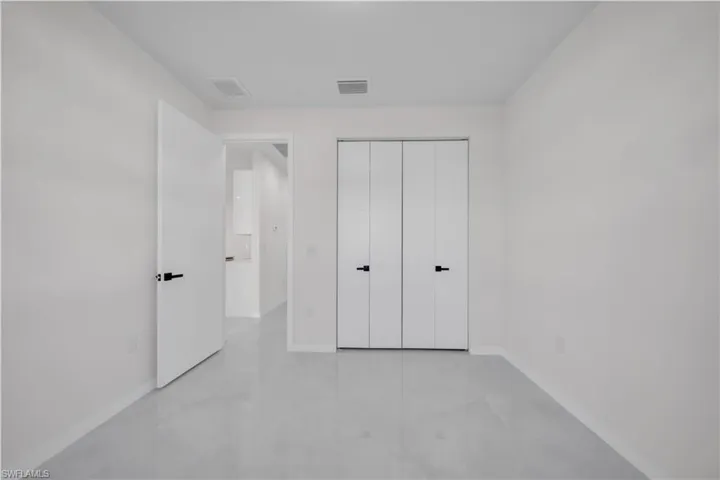 Unfurnished bedroom featuring baseboards and a closet