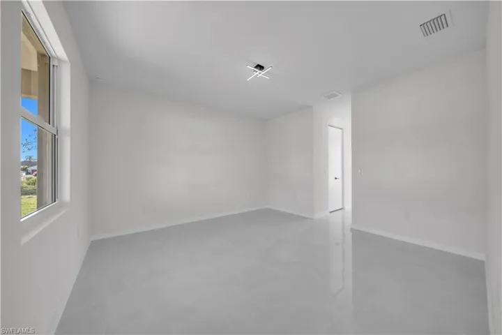 Unfurnished room with baseboards