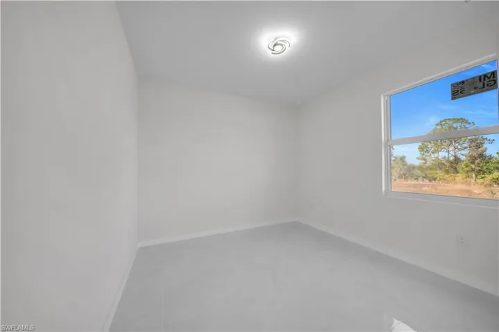 Spare room featuring baseboards