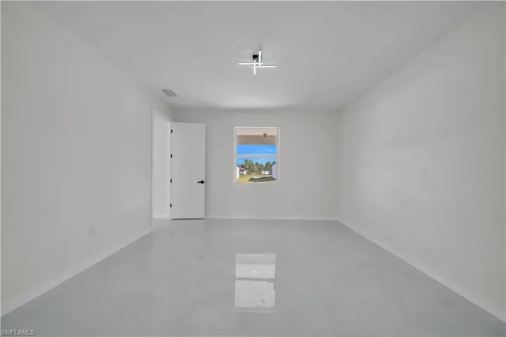 Unfurnished room featuring baseboards