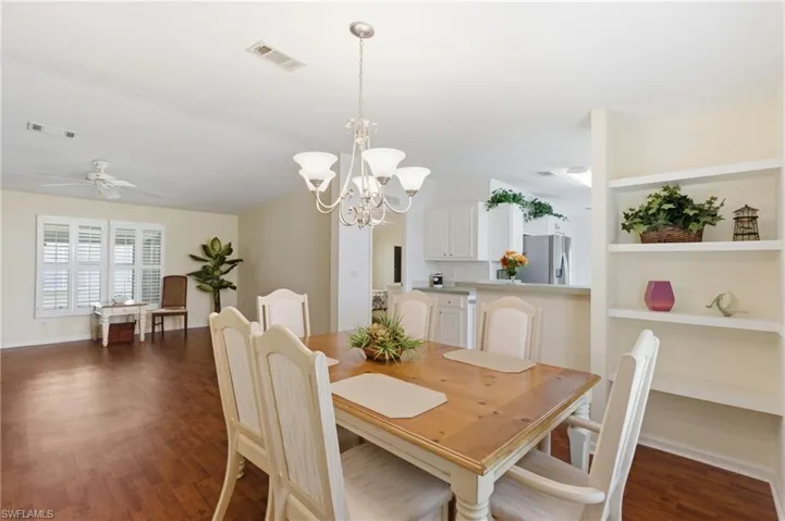Dining area with Family room and Kitchen in background.