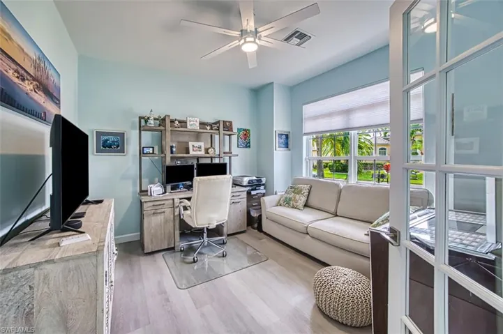 Office area with ceiling fan and light hardwood / wood-style flooring