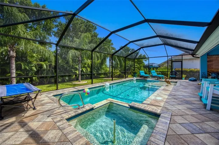 View of pool featuring an in ground hot tub, a lanai, and a patio area