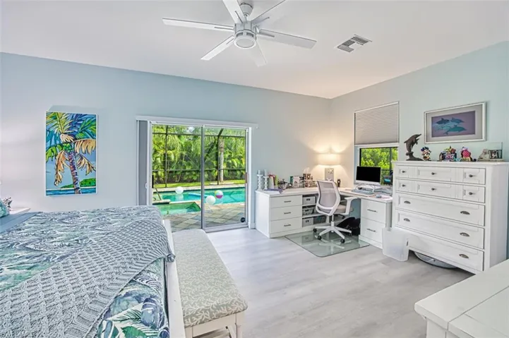 Bedroom with light wood-type flooring, access to outside, and ceiling fan