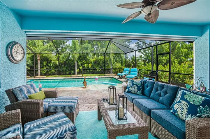 View of swimming pool with a patio, outdoor lounge area, a lanai, and ceiling fan