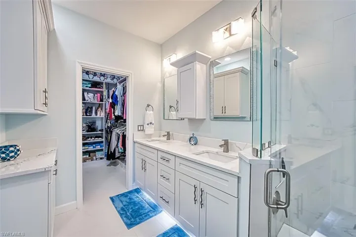 Bathroom with vanity and a shower with door