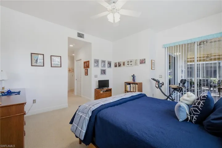 Primary Bedroom with Sliding Glass Doors to Screened Lanai