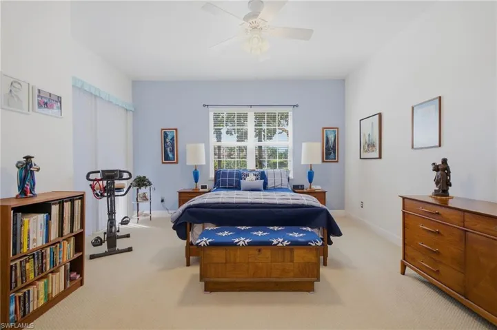 Primary Bedroom with Sliding Glass Doors to Screened Lanai.