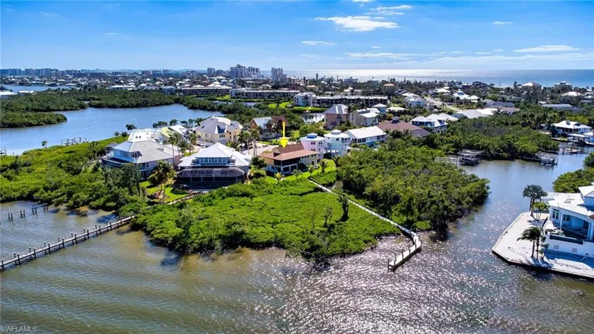 Aerial view of property from Erstero Bay preserve with more the 3/4 acre of land and large composite dock in very quiet residential cul-de-sac on Fort Myers Beach island