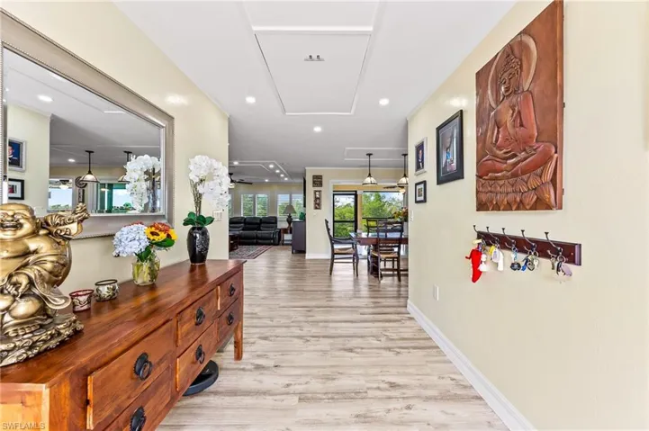 Corridor at the front doo featuring light wood-type flooring and recessed lighting