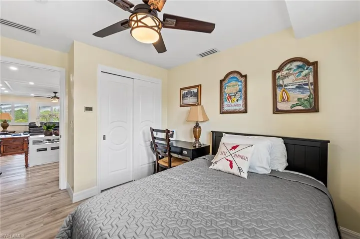 Guest Bedroom with a closet, light wood-style flooring, a ceiling fan, and recessed lighting