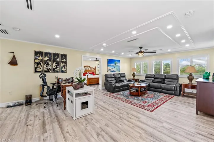 Huge open living room featuring an office area, recessed lighting, light wood finished floors, crown molding, and a ceiling fan