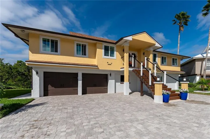 View of front of home with the entrance, and an attached oversized 2-car garage