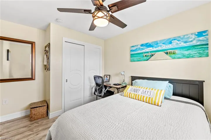 Guest Bedroom featuring a closet, wood finished floors, and ceiling fan