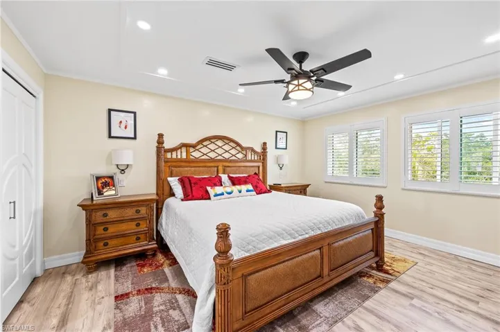Master Bedroom featuring crown molding, a ceiling fan, recessed lighting, light wood-style flooring, and a closet
