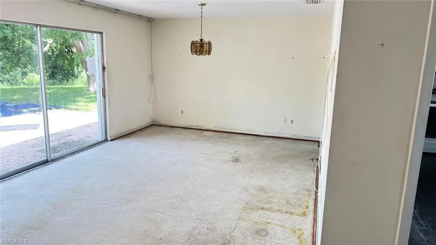 Spare room featuring light carpet